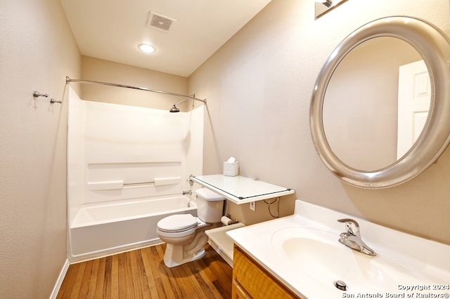 full bathroom featuring bathtub / shower combination, vanity, hardwood / wood-style flooring, and toilet