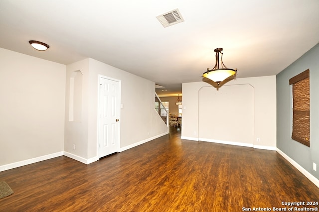 spare room with dark wood-type flooring