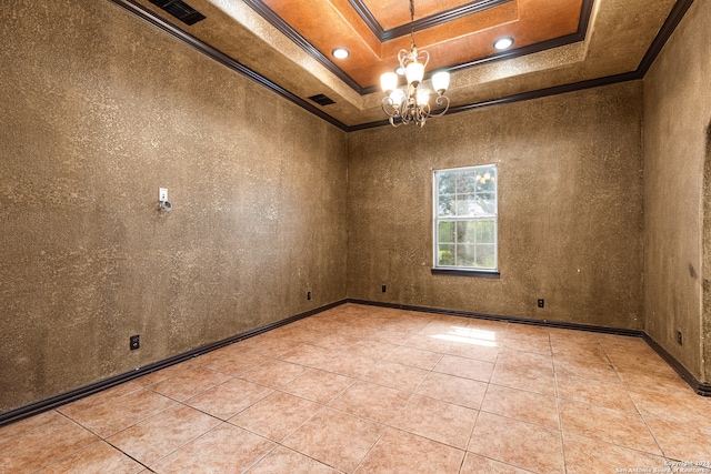 empty room with crown molding, a chandelier, a tray ceiling, and light tile patterned floors