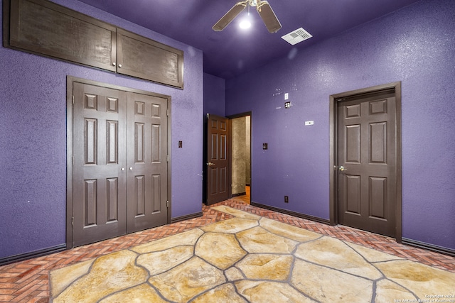 unfurnished bedroom featuring a closet and ceiling fan