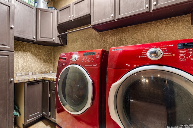 laundry area featuring independent washer and dryer and cabinets