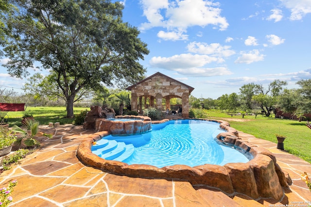 view of swimming pool featuring a patio area, an in ground hot tub, and a lawn