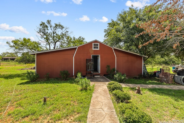 view of outdoor structure featuring a lawn