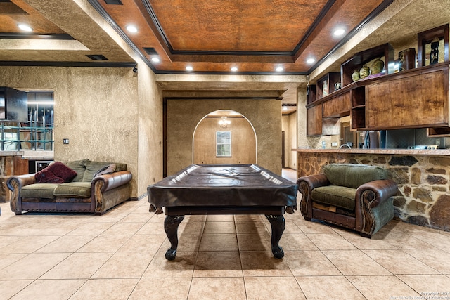 recreation room with pool table, crown molding, light tile patterned flooring, and a tray ceiling