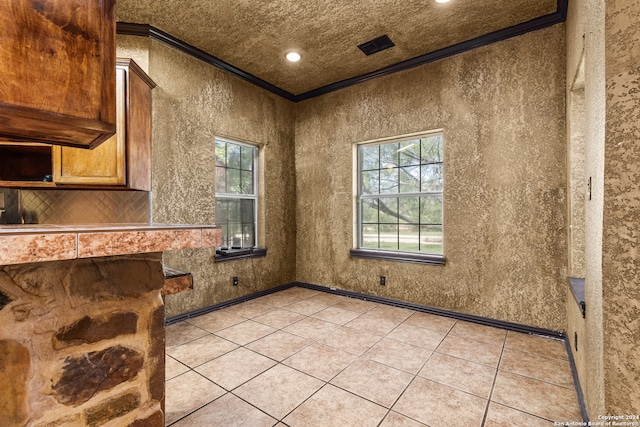 kitchen with ornamental molding and light tile patterned floors