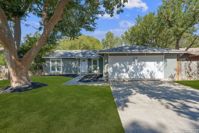 ranch-style home featuring a front lawn and a garage