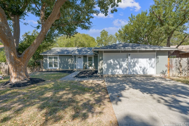 ranch-style house with a front yard and a garage