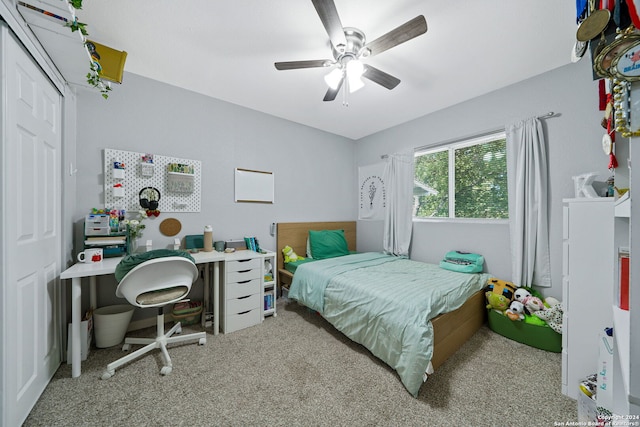 carpeted bedroom with a closet and ceiling fan