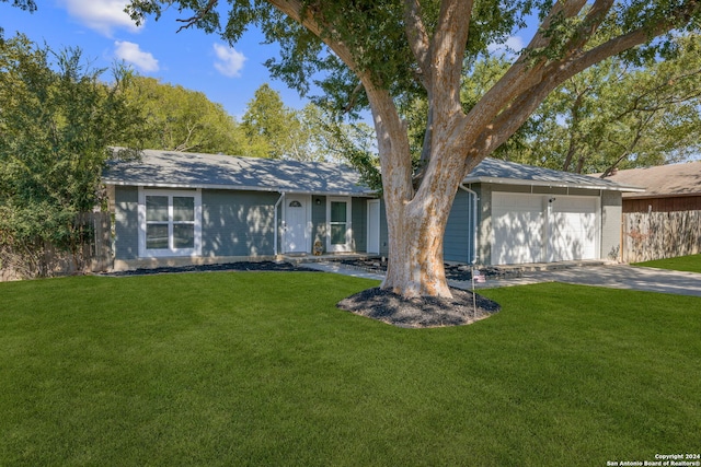 single story home featuring a garage and a front lawn