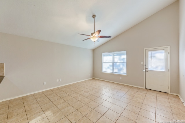 spare room with ceiling fan, high vaulted ceiling, and light tile patterned floors