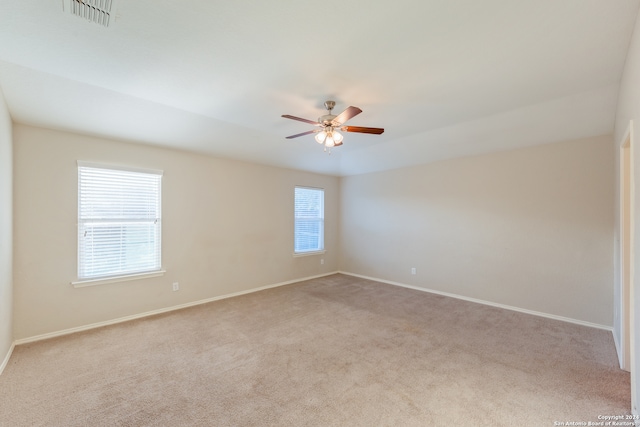 spare room featuring light carpet and ceiling fan