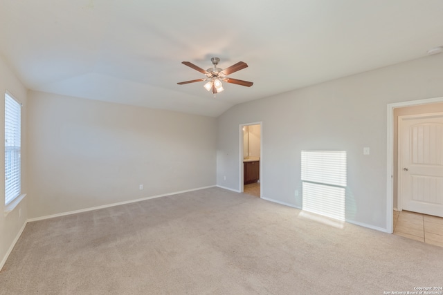 empty room featuring ceiling fan, light colored carpet, and plenty of natural light