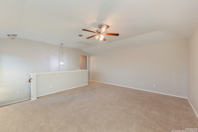 carpeted spare room with lofted ceiling and ceiling fan