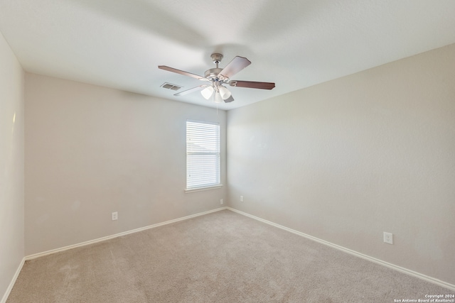 spare room with carpet flooring and ceiling fan