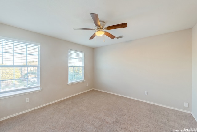 carpeted empty room featuring ceiling fan