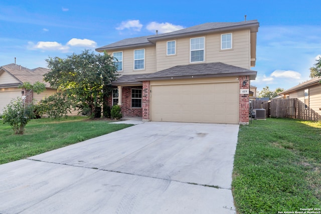 view of front of property featuring a front lawn, central AC unit, and a garage