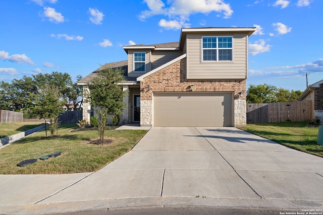 view of front of property with a front yard and a garage