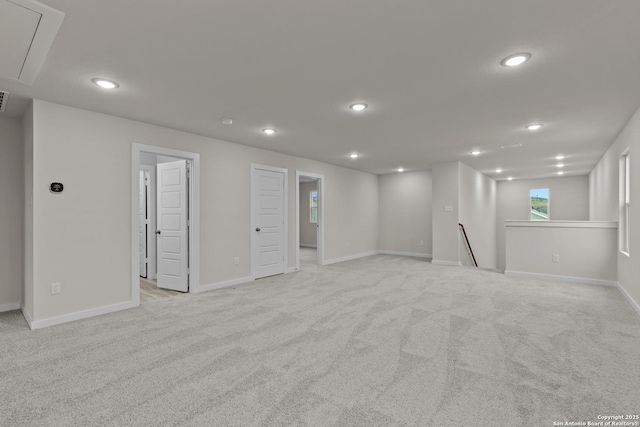 basement featuring light carpet