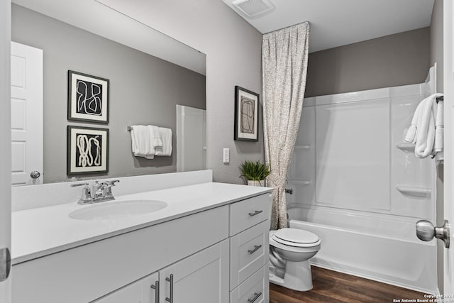 full bathroom with vanity, shower / tub combo with curtain, toilet, and hardwood / wood-style flooring