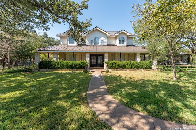 view of front facade featuring covered porch, a front lawn, and a trampoline