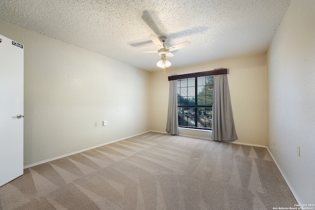 unfurnished room with light carpet, a textured ceiling, and ceiling fan