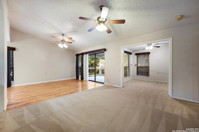 empty room featuring light hardwood / wood-style flooring, a textured ceiling, and ceiling fan