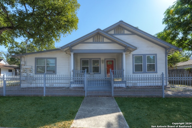 view of front of house with a front yard and covered porch