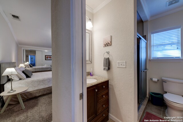 bathroom featuring vanity, an enclosed shower, crown molding, and toilet