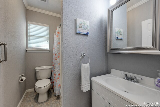 bathroom with vanity, crown molding, and toilet