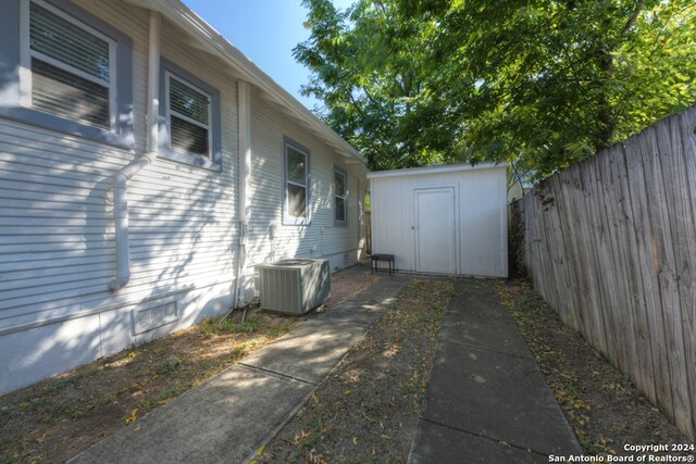 view of side of property with a shed and central air condition unit