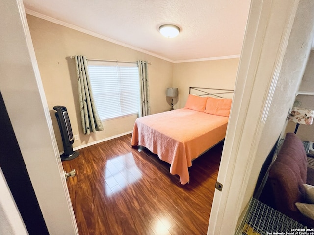 bedroom featuring ornamental molding, vaulted ceiling, a textured ceiling, and dark hardwood / wood-style flooring