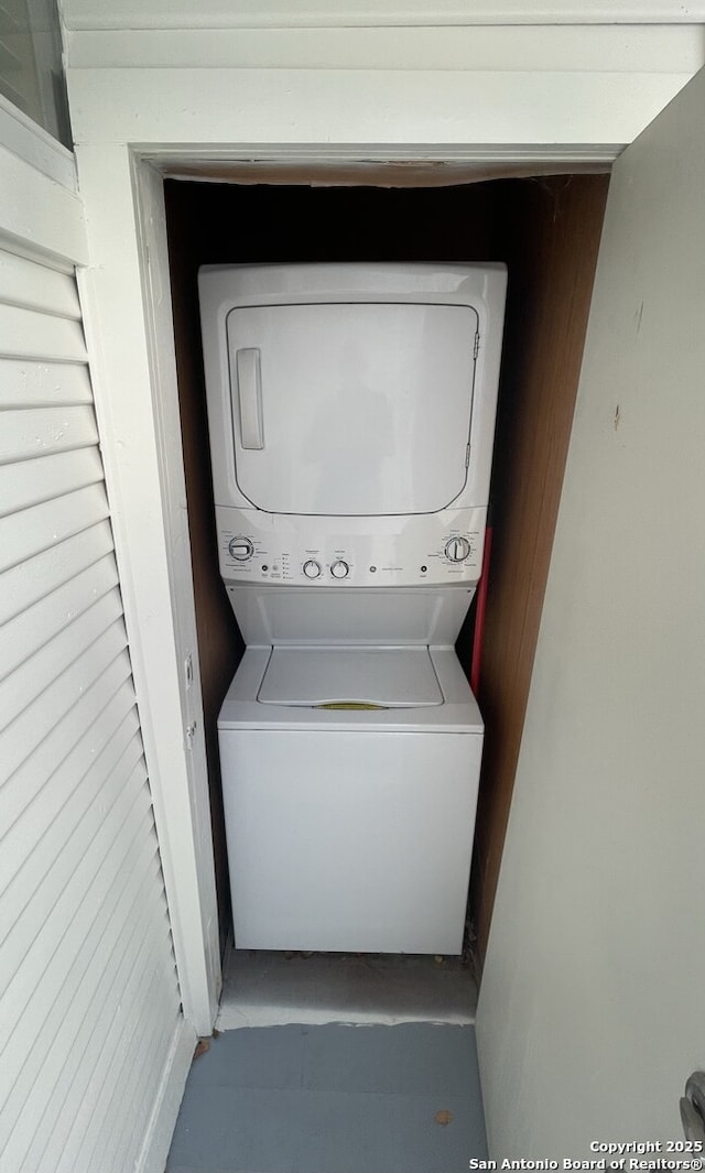 laundry area featuring stacked washer and clothes dryer