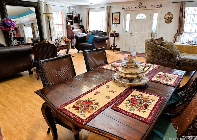 dining space featuring ornamental molding and wood-type flooring