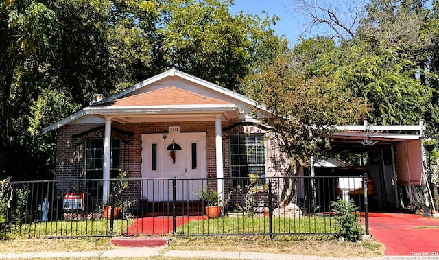 bungalow-style house featuring a porch, a front lawn, and a carport