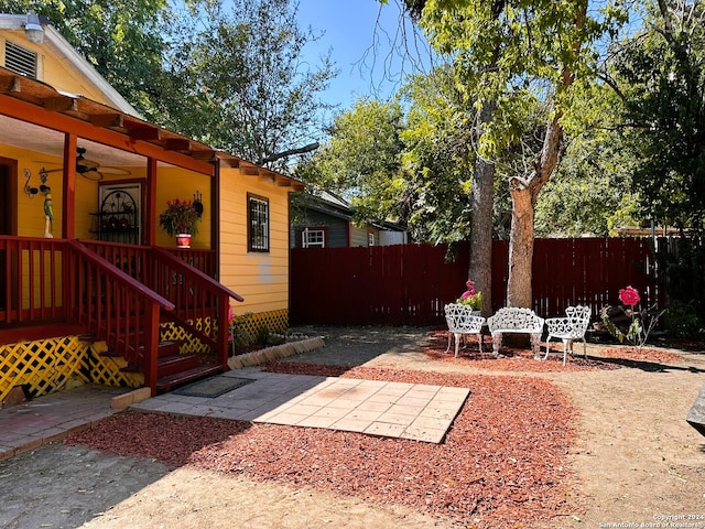 view of yard with a patio area and ceiling fan