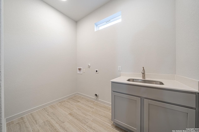 clothes washing area featuring hookup for an electric dryer, a sink, baseboards, hookup for a washing machine, and cabinet space