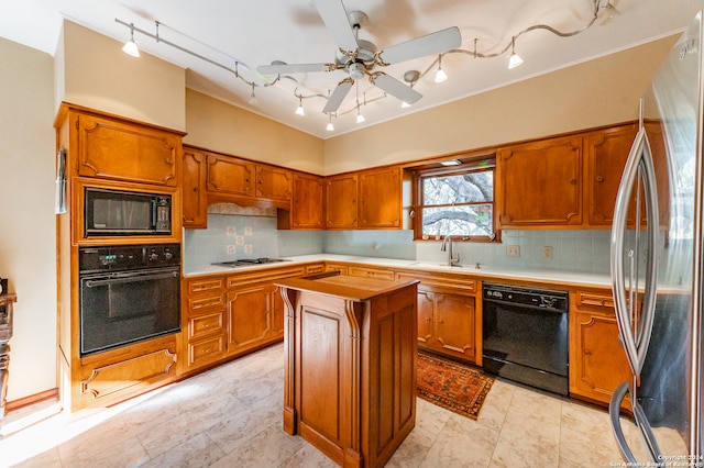 kitchen featuring tasteful backsplash, black appliances, ceiling fan, and a kitchen island