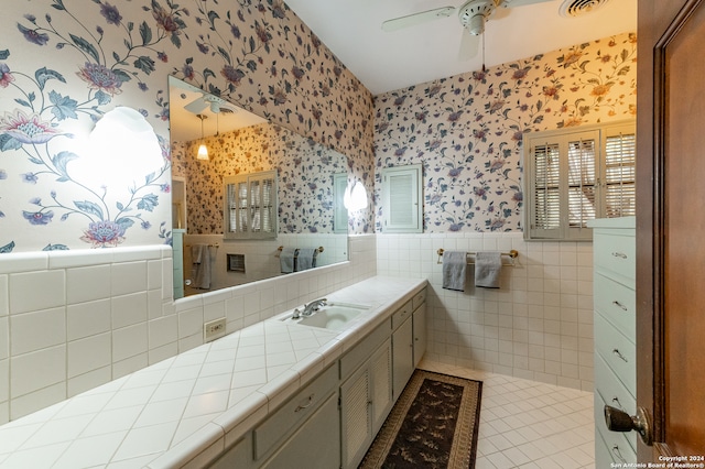 bathroom featuring vanity, ceiling fan, tile patterned floors, and tile walls