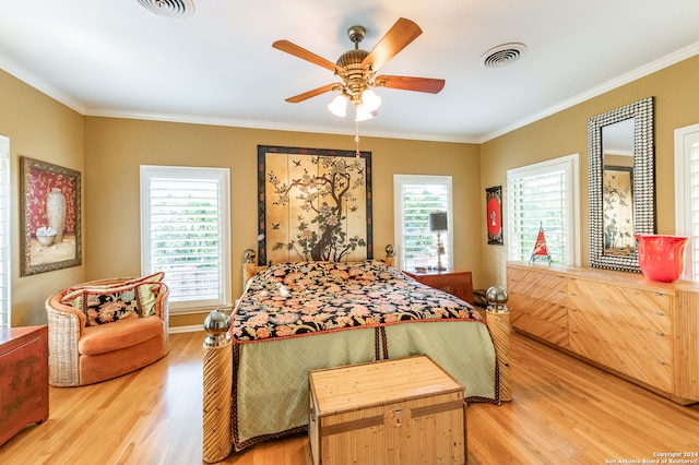 bedroom with ornamental molding, wood-type flooring, and ceiling fan