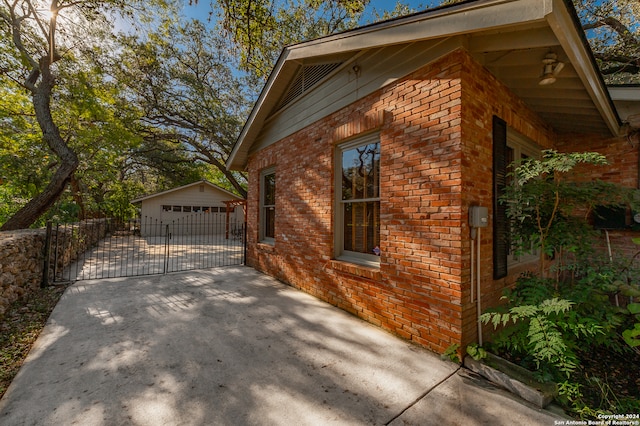 view of property exterior featuring an outdoor structure and a garage