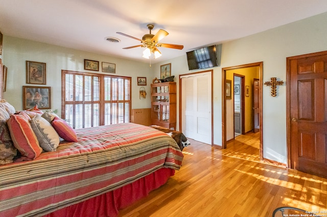 bedroom with a closet, ceiling fan, and light wood-type flooring