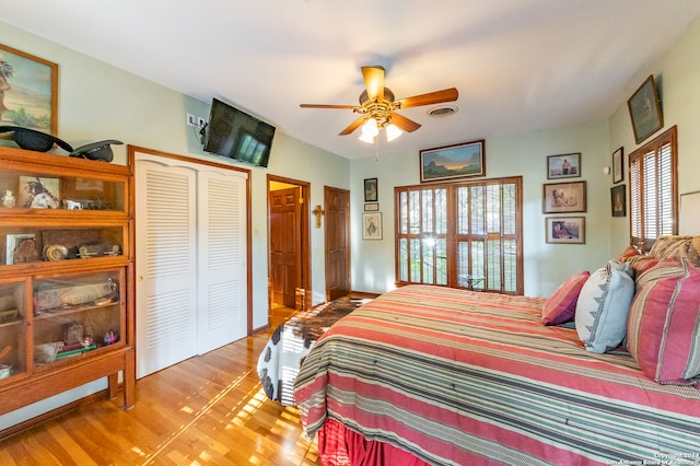 bedroom featuring light hardwood / wood-style flooring, a closet, and ceiling fan