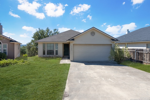 view of front of home featuring a front yard and a garage