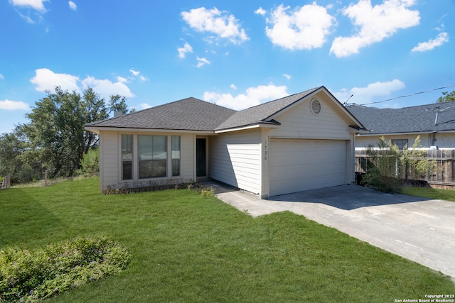 single story home with a front yard and a garage