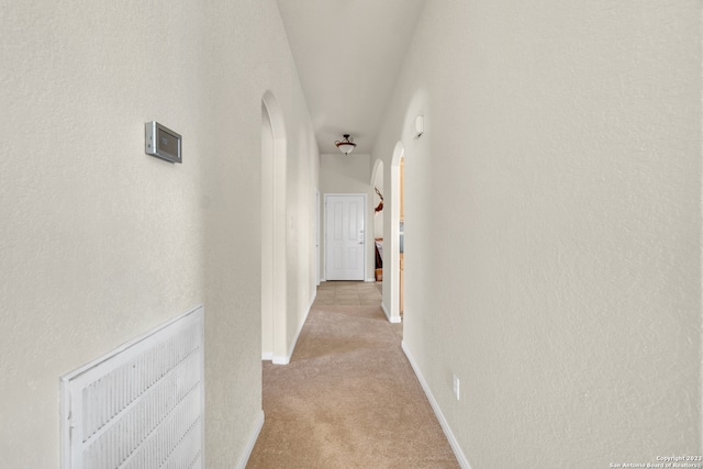 hall featuring light colored carpet