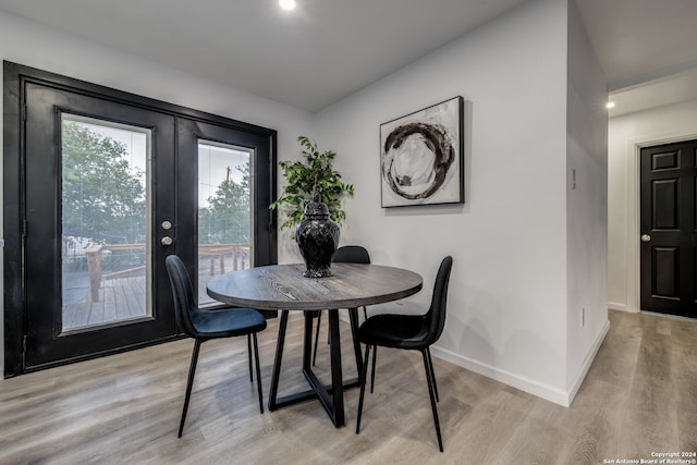 dining area featuring french doors and light hardwood / wood-style flooring