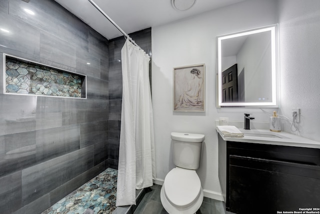 bathroom featuring walk in shower, vanity, and toilet