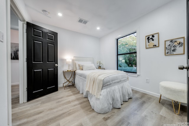 bedroom with light hardwood / wood-style floors