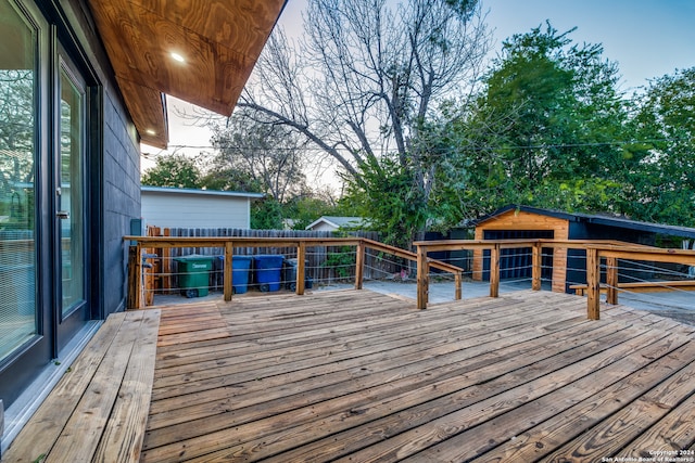 wooden terrace featuring an outbuilding