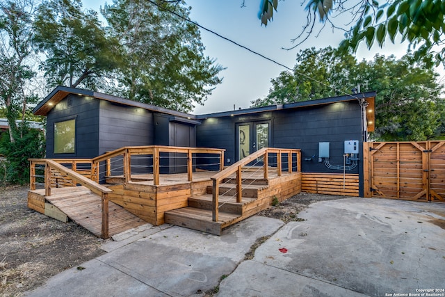 back of house featuring a patio area, a deck, and french doors